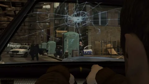 A bullet rips a hole through the windscreen.