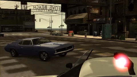 Niko pulls away from a police car in a blue Stallion.