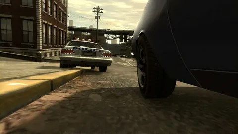 Niko tails a police car over a curb.
