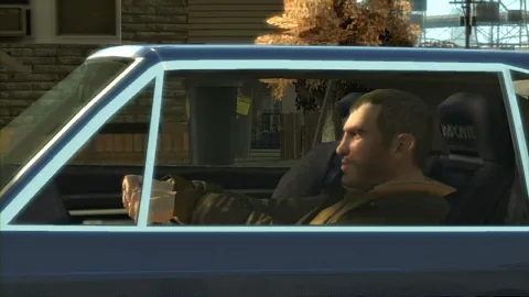 Niko drives past some small houses.