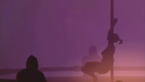 Girls dance in a strip club