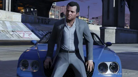 Michael sits on a car