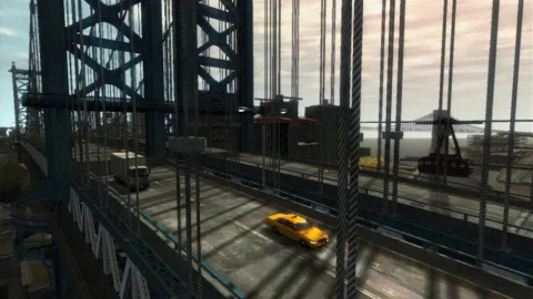 A few vehicles drive across a large bridge.