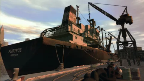 A large ship moored at the docks with some builders nearby.