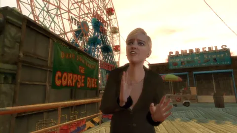 A woman standing outside a fair ground waves her arms.