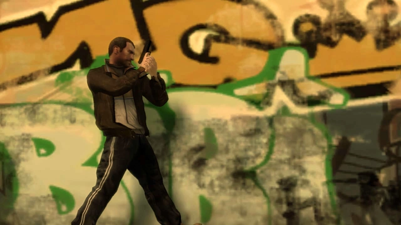 Niko walks along a grafitti covered wall, gun drawn.