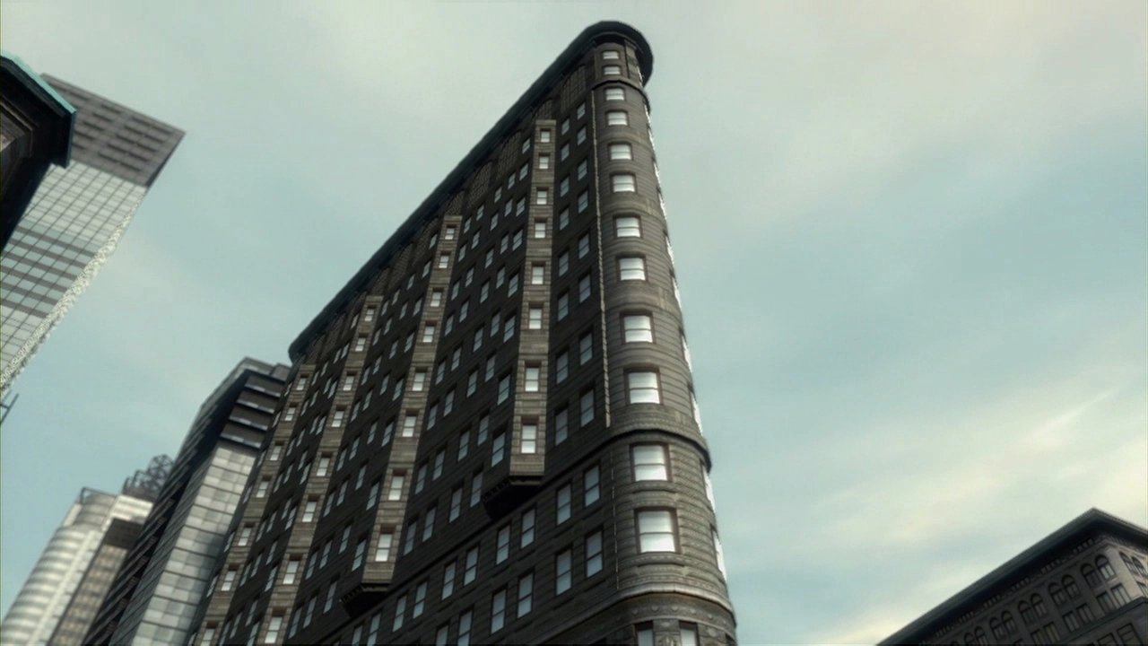 A triangular building separates two streets.