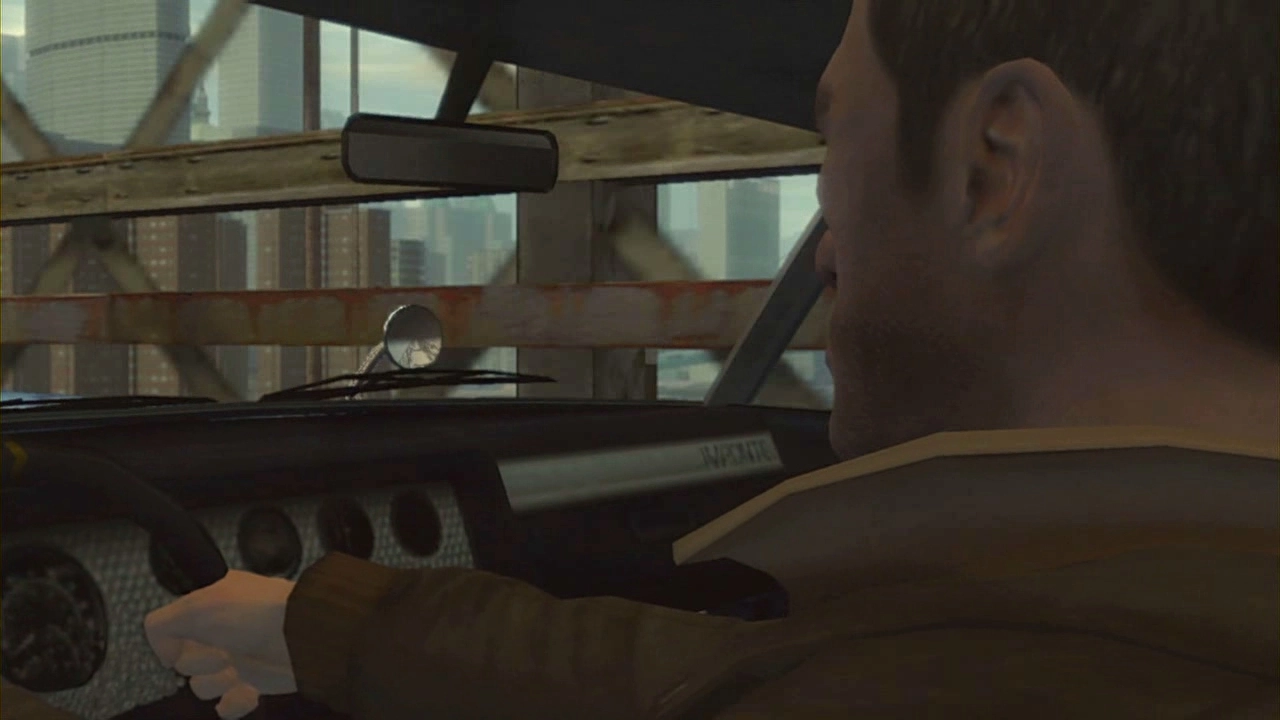 Niko checks his mirrors as he drives across the bridge.