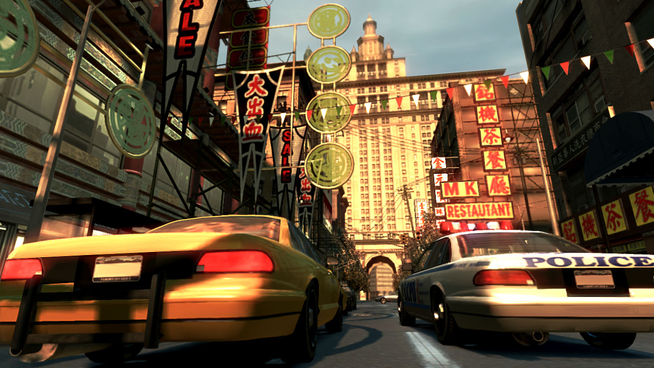 A taxi and police car travel through China Town.