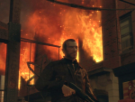 Niko walks past a burning building
