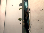 Niko kicks a locked door open.