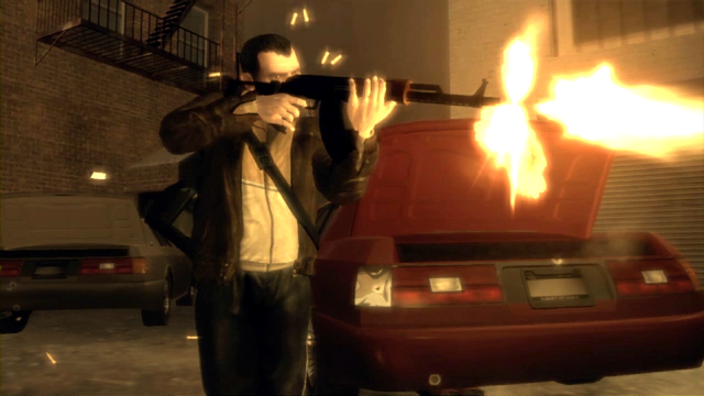 Niko fires an AK-47 from the cover of some parked cars.